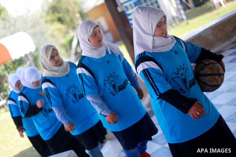 Iman al-Tanani, a 28-year-old a Palestinian woman with Down syndrome plays basketball with her friends in Gaza city on Feb. 16, 2017. al-Tanani got work from United Nations Relief and Works Agency (UNRWA) on handmade, mo...