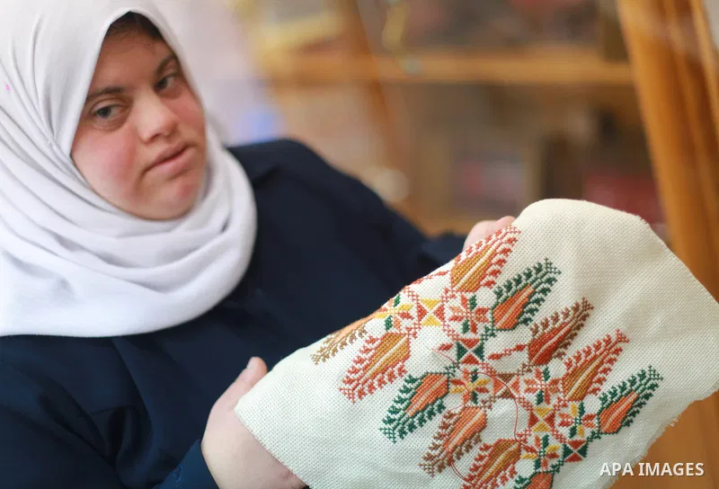 Iman al-Tanani, a 28-year-old a Palestinian woman with Down syndrome works on embroidery in Gaza city on Feb. 16, 2017. al-Tanani got work from United Nations Relief and Works Agency (UNRWA) on handmade, moreover she pla...
