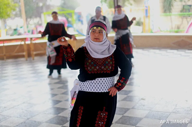 Iman al-Tanani, a 28-year-old a Palestinian woman with Down syndrome wears a traditional dress, as she dances dabka in Gaza city on Feb. 16, 2017. al-Tanani got work from United Nations Relief and Works Agency (UNRWA) on...