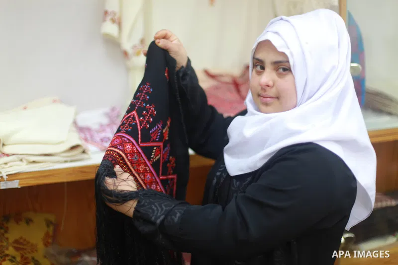 Iman al-Tanani, a 28-year-old a Palestinian woman with Down syndrome works on embroidery in Gaza city on Feb. 16, 2017. al-Tanani got work from United Nations Relief and Works Agency (UNRWA) on handmade, moreover she pla...