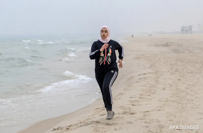Dania El Masry, 20-years old a Paletinian woman from Khan younis student of Physical Therapy, runs on the beach as she plays CrossFit sport in the southern Gaza strip, on Feb. 07, 2017. CrossFit workouts incorporate elem...