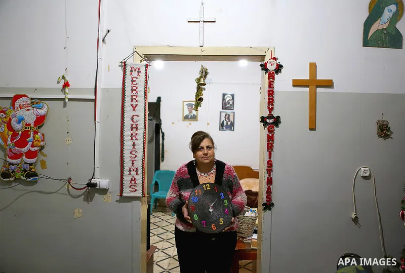 Evet Azzam, a Palestinian Christians woman, 53, makes a handmade clock from recycled newspapers at her house, in Gaza city on Feb. 10, 2017. Azzam uses an useless home materials to produce clocks, Nylon bags, chairs and...