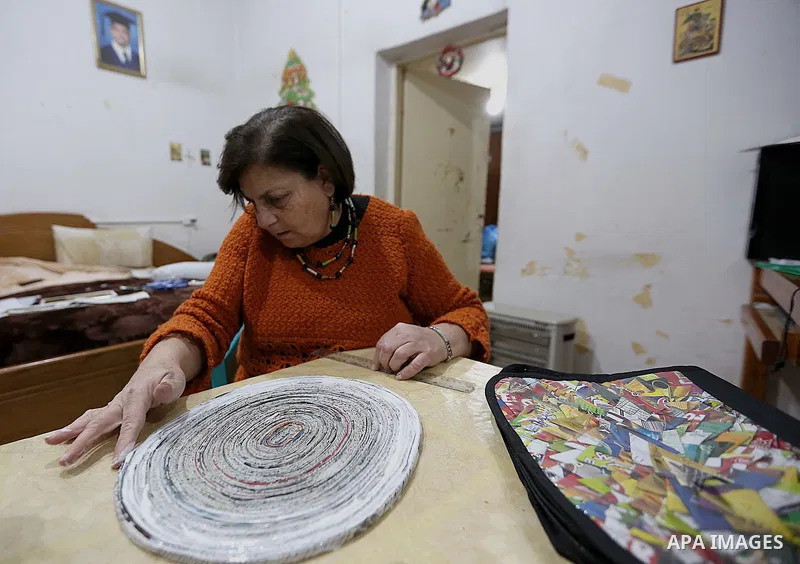 Evet Azzam, a Palestinian Christians woman, 53, makes a handmade clock from recycled newspapers at her house, in Gaza city on Feb. 10, 2017. Azzam uses an useless home materials to produce clocks, Nylon bags, chairs and...