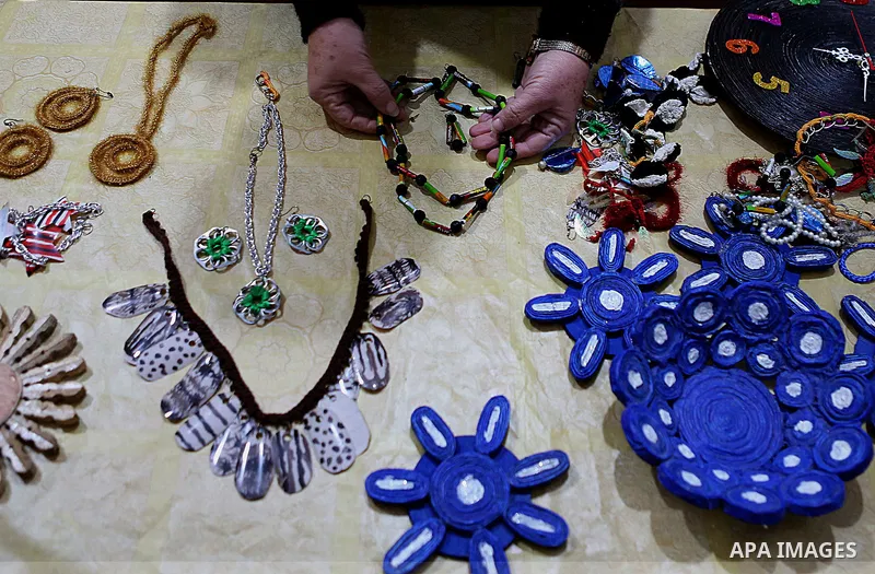 Evet Azzam, a Palestinian Christians woman, 53, makes a handmade clock from recycled newspapers at her house, in Gaza city on Feb. 10, 2017. Azzam uses an useless home materials to produce clocks, Nylon bags, chairs and...
