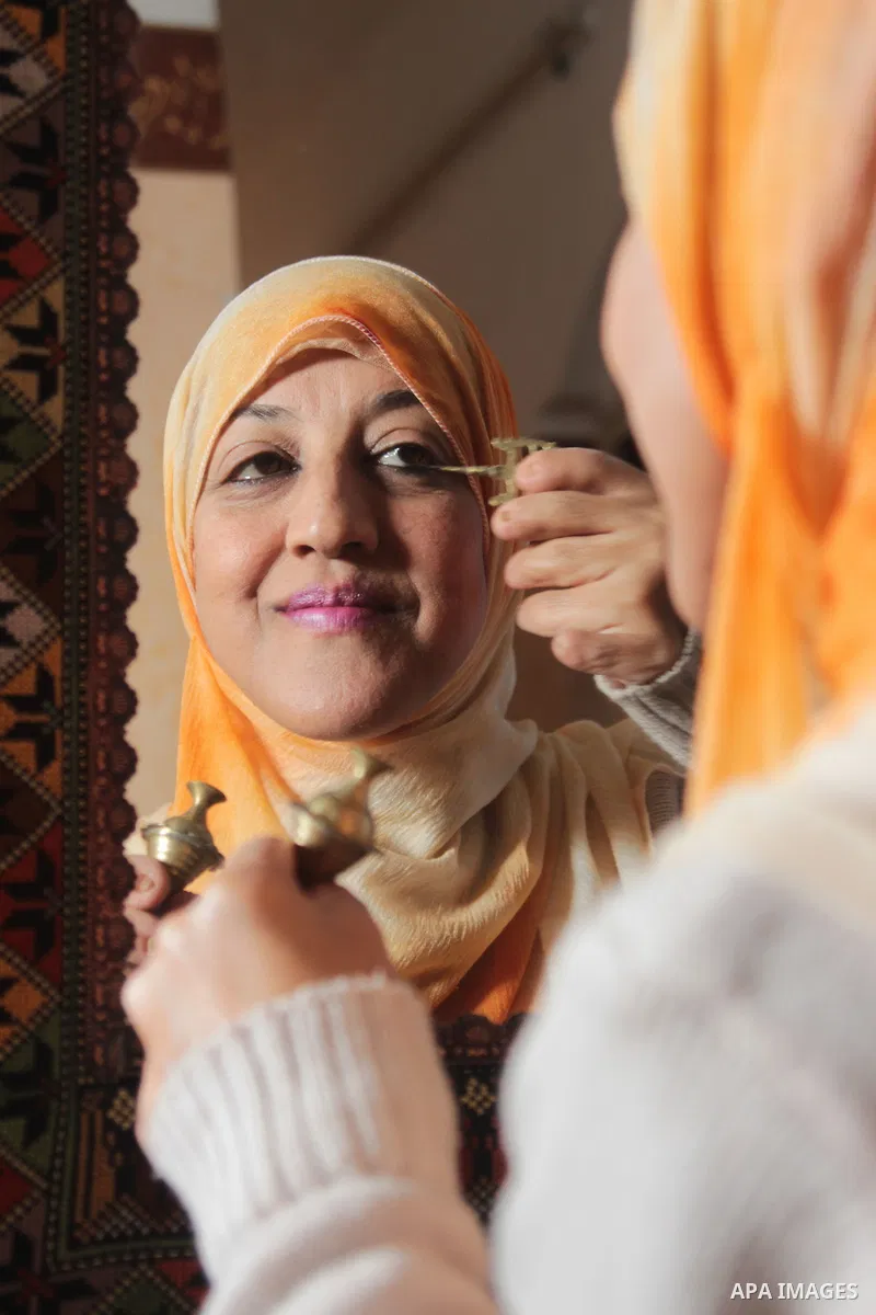 Sawsan Al Khalili, 40 years-old, a Palestinian woman of special needs applies makeup at her house in Gaza city on Feb. 11, 2017. Al Khalili secretary general of the general union of the Palestinian disabled and a head of...