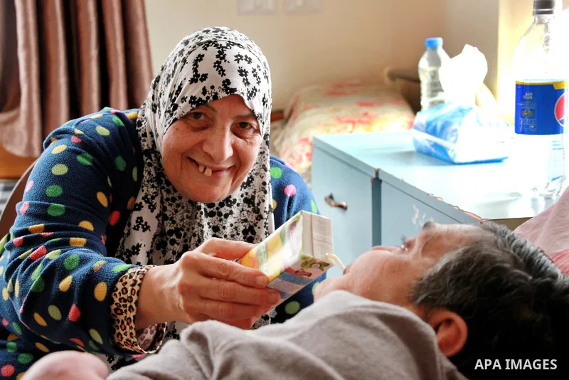 An elderly Palestinian woman help her friend at El Wafa elderly nursing home, in Gaza city on Feb. 12, 2017. El Wafa elderly nursing home was established in 1980 as one of programs of Al-Wafa charity association. El-Wafa...