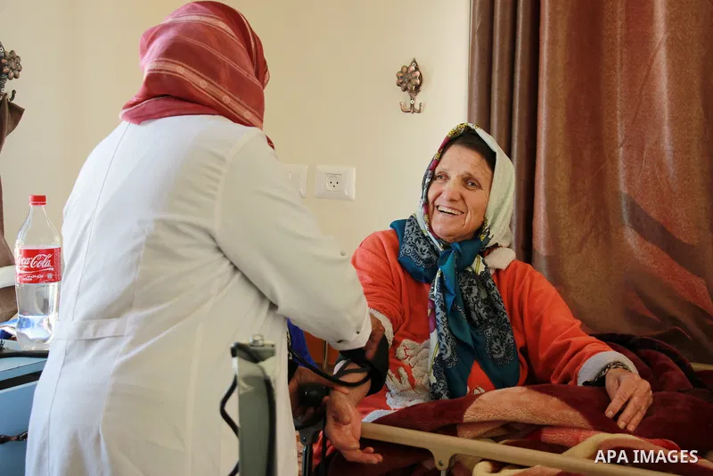 A Palestinian nurse provides treatment for an elderly Palestinian woman at El Wafa elderly nursing home, in Gaza city on Feb. 12, 2017. El Wafa elderly nursing home was established in 1980 as one of programs of Al-Wafa c...