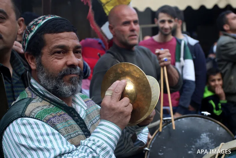 Palestinians Muslim Sufis play musical instruments as they parade through the streets during a ceremony commemorating the Islamic holiday of Isra Mi'raj in the West Bank city of Nablus on April 24, 2017. The holiday mark...