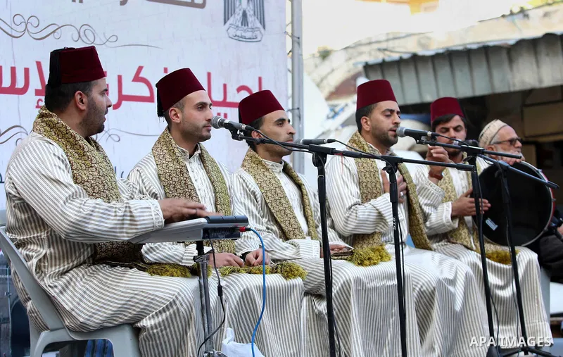Palestinians Muslim Sufis play musical instruments as they parade through the streets during a ceremony commemorating the Islamic holiday of Isra Mi'raj in the West Bank city of Nablus on April 24, 2017. The holiday mark...