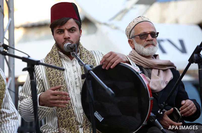 Palestinians Muslim Sufis play musical instruments as they parade through the streets during a ceremony commemorating the Islamic holiday of Isra Mi'raj in the West Bank city of Nablus on April 24, 2017. The holiday mark...