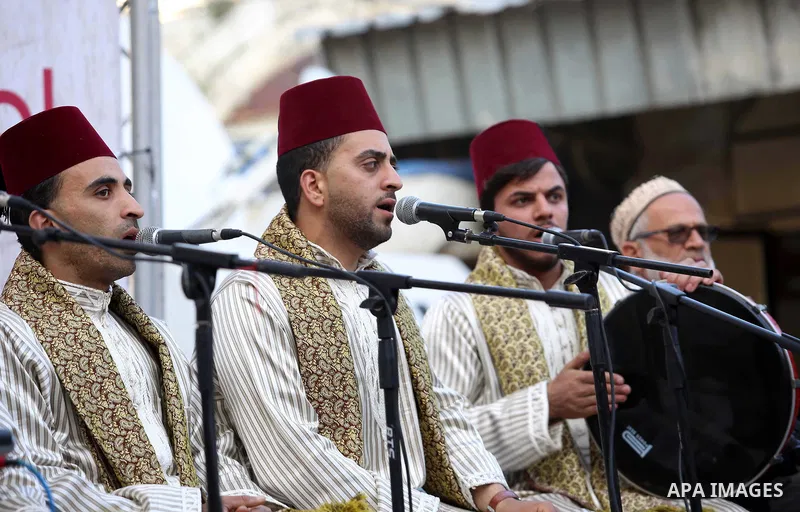 Palestinians Muslim Sufis play musical instruments as they parade through the streets during a ceremony commemorating the Islamic holiday of Isra Mi'raj in the West Bank city of Nablus on April 24, 2017. The holiday mark...