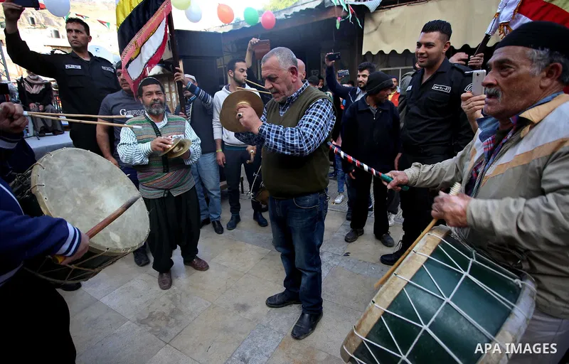 Palestinians Muslim Sufis play musical instruments as they parade through the streets during a ceremony commemorating the Islamic holiday of Isra Mi'raj in the West Bank city of Nablus on April 24, 2017. The holiday mark...