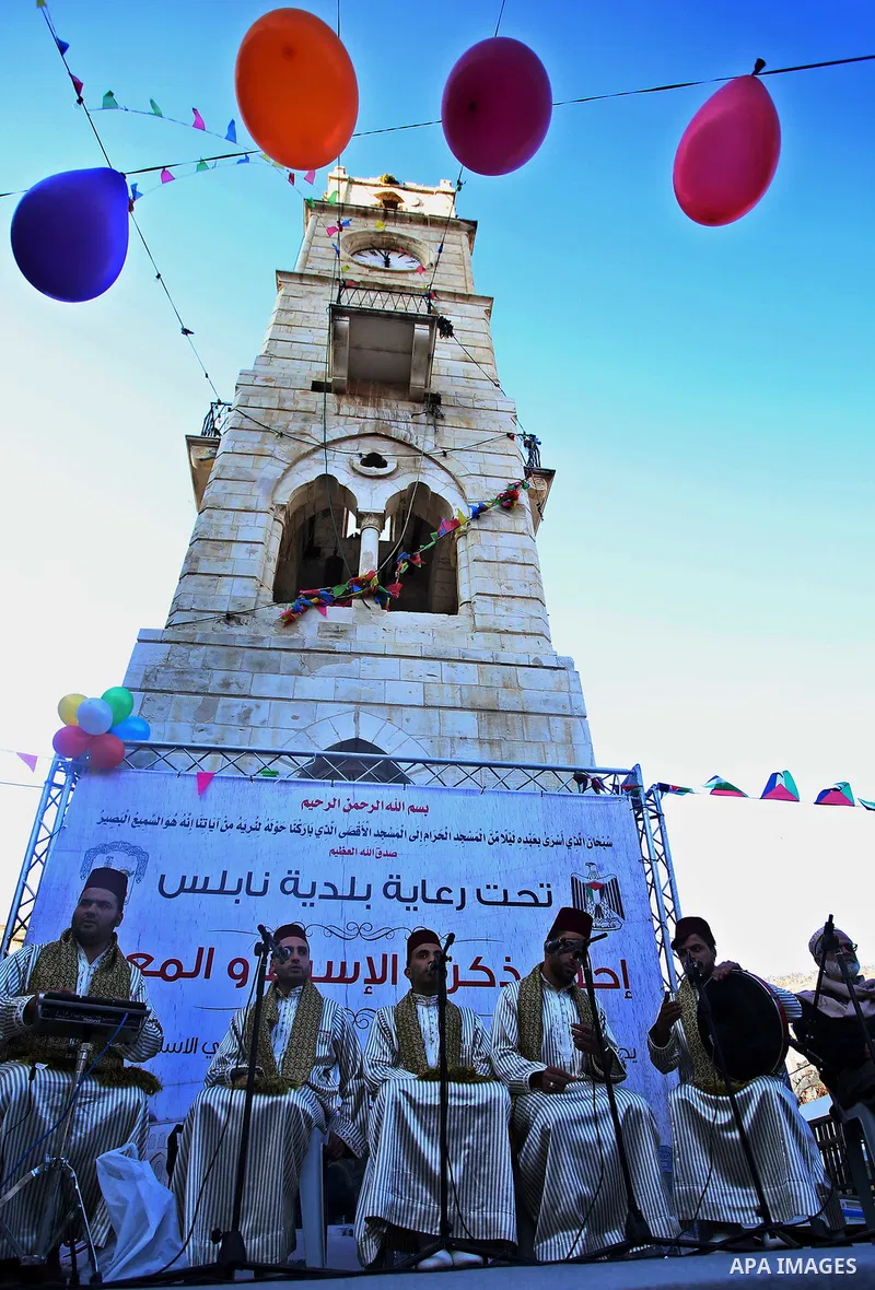 Palestinians Muslim Sufis play musical instruments as they parade through the streets during a ceremony commemorating the Islamic holiday of Isra Mi'raj in the West Bank city of Nablus on April 24, 2017. The holiday mark...