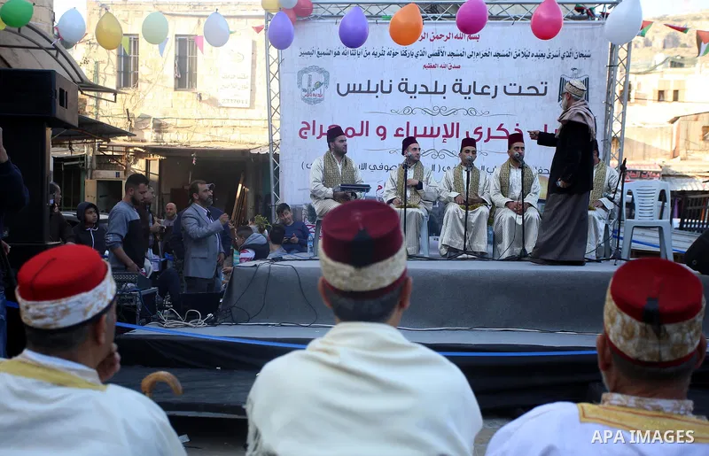 Palestinians Muslim Sufis play musical instruments as they parade through the streets during a ceremony commemorating the Islamic holiday of Isra Mi'raj in the West Bank city of Nablus on April 24, 2017. The holiday mark...