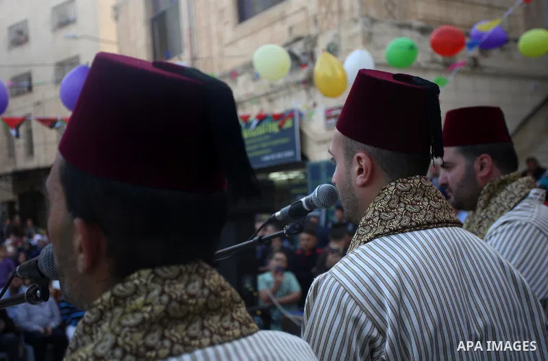 Palestinians Muslim Sufis play musical instruments as they parade through the streets during a ceremony commemorating the Islamic holiday of Isra Mi'raj in the West Bank city of Nablus on April 24, 2017. The holiday mark...