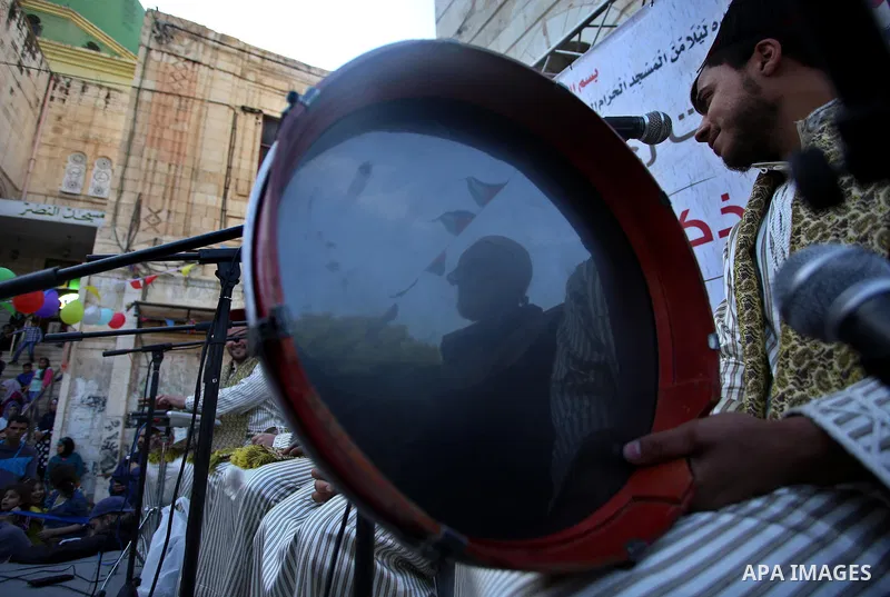Palestinians Muslim Sufis play musical instruments as they parade through the streets during a ceremony commemorating the Islamic holiday of Isra Mi'raj in the West Bank city of Nablus on April 24, 2017. The holiday mark...