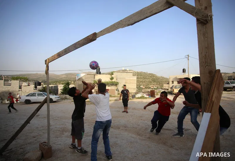 A picture taken on April 22, 2017 shows Palestinian boys play football, in the West Bank city of Nablus. Photo by Ayman Ameen