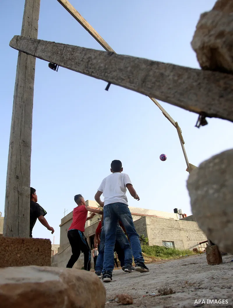 A picture taken on April 22, 2017 shows Palestinian boys play football, in the West Bank city of Nablus. Photo by Ayman Ameen