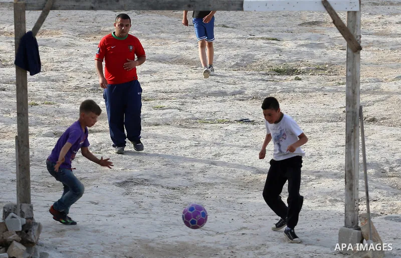 A picture taken on April 22, 2017 shows Palestinian boys play football, in the West Bank city of Nablus. Photo by Ayman Ameen