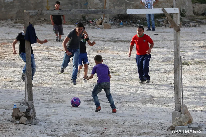 A picture taken on April 22, 2017 shows Palestinian boys play football, in the West Bank city of Nablus. Photo by Ayman Ameen