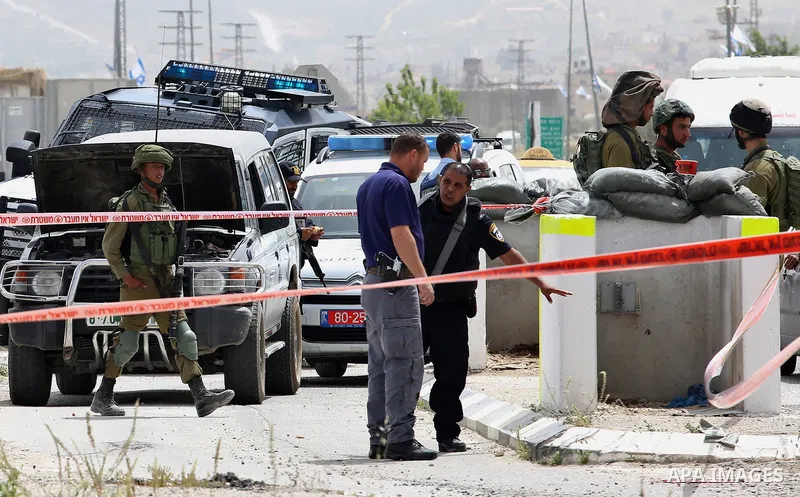 Israeli security forces gather at the site where a Palestinian teenager attempted to stab an Israeli soldier before being shot, at the Hawara checkpoint near the West Bank city of Nablus, on April 26, 2017. A Palestinian...