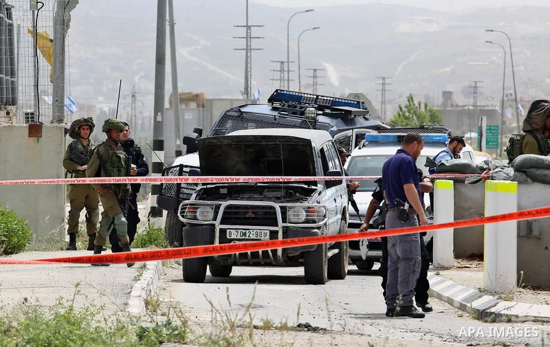 Israeli security forces gather at the site where a Palestinian teenager attempted to stab an Israeli soldier before being shot, at the Hawara checkpoint near the West Bank city of Nablus, on April 26, 2017. A Palestinian...