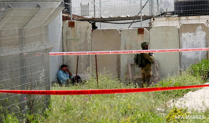 Israeli security forces gather at the site where a Palestinian teenager attempted to stab an Israeli soldier before being shot, at the Hawara checkpoint near the West Bank city of Nablus, on April 26, 2017. A Palestinian...