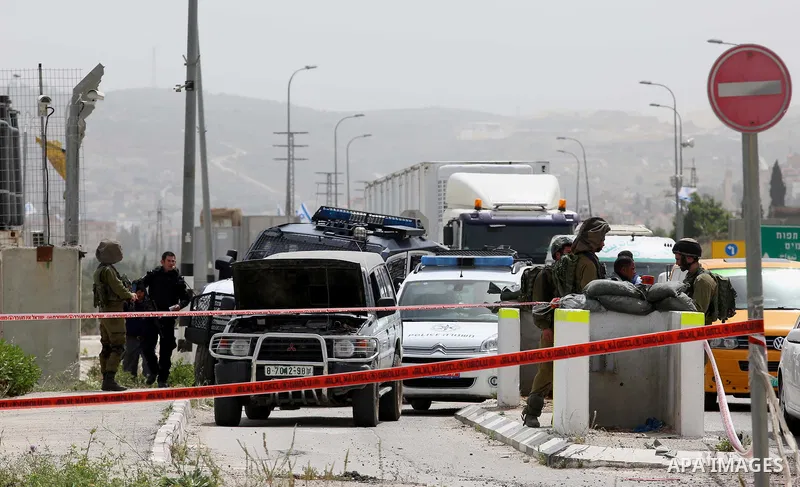 Israeli security forces gather at the site where a Palestinian teenager attempted to stab an Israeli soldier before being shot, at the Hawara checkpoint near the West Bank city of Nablus, on April 26, 2017. A Palestinian...