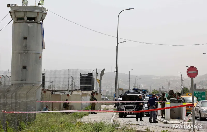 Israeli security forces gather at the site where a Palestinian teenager attempted to stab an Israeli soldier before being shot, at the Hawara checkpoint near the West Bank city of Nablus, on April 26, 2017. A Palestinian...