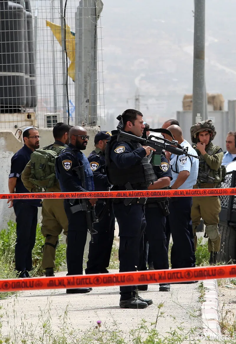 Israeli security forces gather at the site where a Palestinian teenager attempted to stab an Israeli soldier before being shot, at the Hawara checkpoint near the West Bank city of Nablus, on April 26, 2017. A Palestinian...