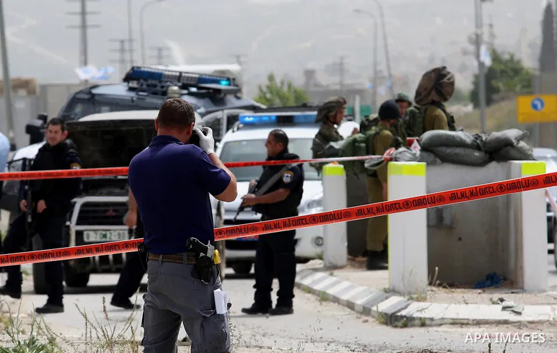 Israeli security forces gather at the site where a Palestinian teenager attempted to stab an Israeli soldier before being shot, at the Hawara checkpoint near the West Bank city of Nablus, on April 26, 2017. A Palestinian...