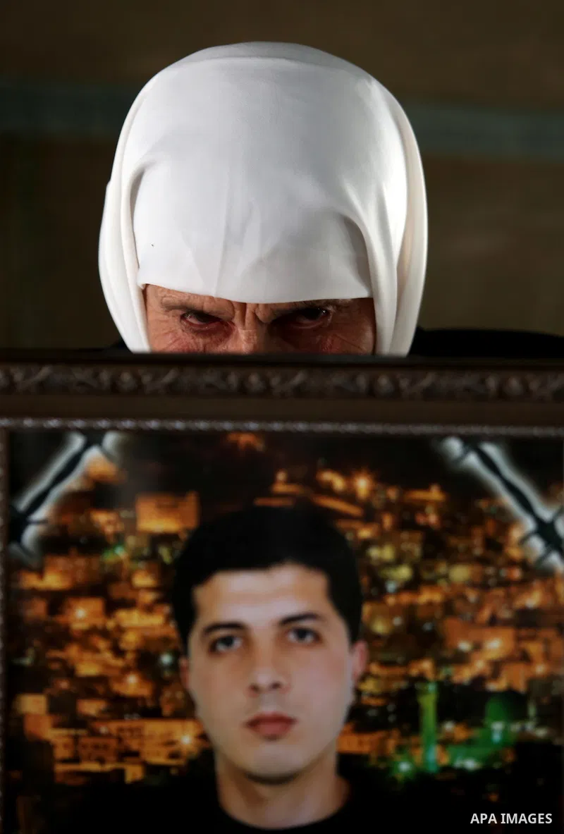 A Palestinian woman holds a picture of her son who held in Israeli jails at a protest tent in support of Palestinian prisoners on hunger strike in Israeli jails, in the West Bank city of Nablus on April 26, 2017. Photo b...