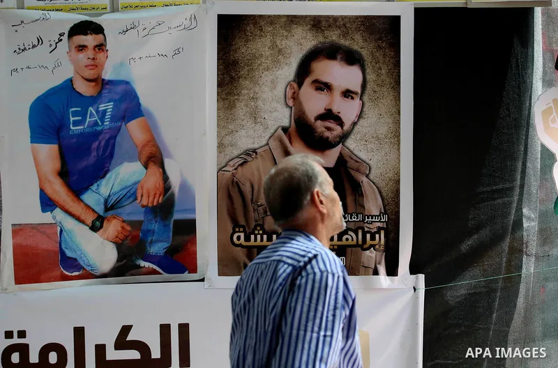 A Palestinian man walks past a a protest tent in support of Palestinian prisoners on hunger strike in Israeli jails, in the West Bank city of Nablus on April 26, 2017. Photo by Ayman Ameen