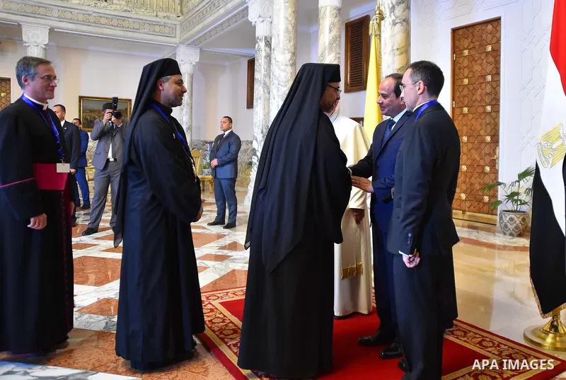 Egyptian President Abdel Fattah al-Sisi shakes hands with clergymen as Pope Francis looks on during a meeting at the presidential palace in Cairo, during an official visit to Egypt on April 28, 2017. Pope Francis began a...