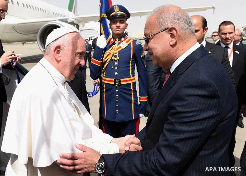 Pope Francis is greeted by officials upon his arrival at Cairo's International Airport on April 28, 2017, during an official visit to Egypt. Pope Francis began a visit to Egypt to promote "unity and fraternity" among Mus...