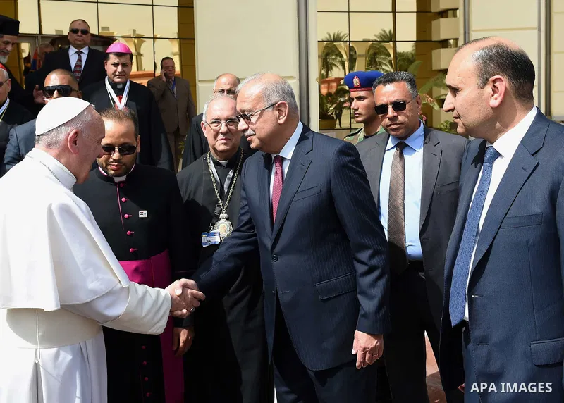 Pope Francis disembarks from his plane upon his arrival at Cairo's International Airport on April 28, 2017, during an official visit to Egypt. Pope Francis began a visit to Egypt to promote "unity and fraternity" among M...