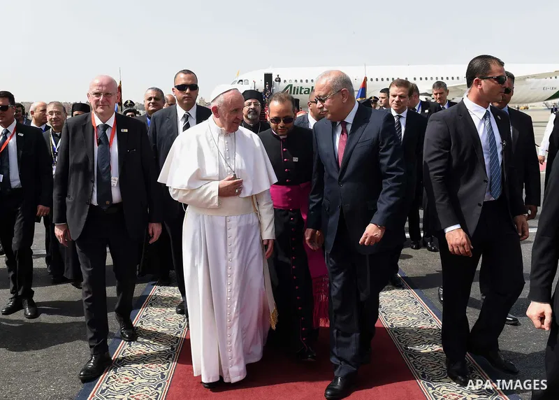 Pope Francis disembarks from his plane upon his arrival at Cairo's International Airport on April 28, 2017, during an official visit to Egypt. Pope Francis began a visit to Egypt to promote "unity and fraternity" among M...