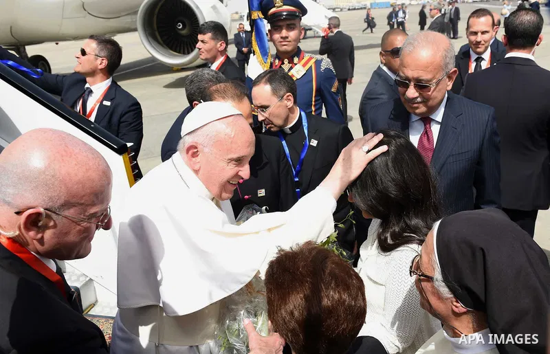 Pope Francis is greeted by officials upon his arrival at Cairo's International Airport on April 28, 2017, during an official visit to Egypt. Pope Francis began a visit to Egypt to promote "unity and fraternity" among Mus...