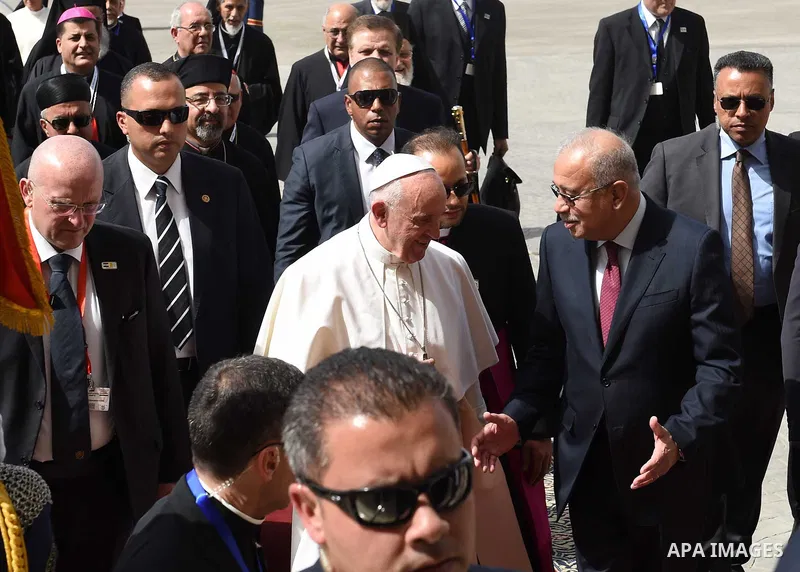 Pope Francis disembarks from his plane upon his arrival at Cairo's International Airport on April 28, 2017, during an official visit to Egypt. Pope Francis began a visit to Egypt to promote "unity and fraternity" among M...