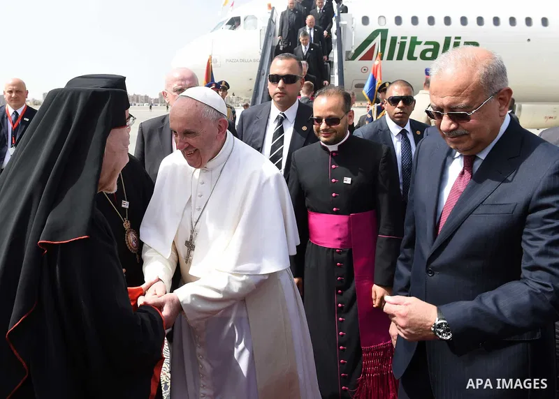 Pope Francis is greeted by officials upon his arrival at Cairo's International Airport on April 28, 2017, during an official visit to Egypt. Pope Francis began a visit to Egypt to promote "unity and fraternity" among Mus...