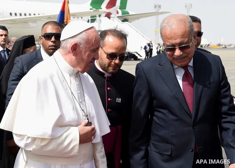 Pope Francis is greeted by officials upon his arrival at Cairo's International Airport on April 28, 2017, during an official visit to Egypt. Pope Francis began a visit to Egypt to promote "unity and fraternity" among Mus...