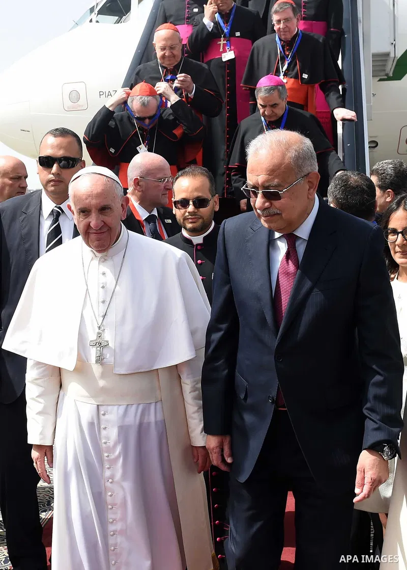 Pope Francis is greeted by officials upon his arrival at Cairo's International Airport on April 28, 2017, during an official visit to Egypt. Pope Francis began a visit to Egypt to promote "unity and fraternity" among Mus...