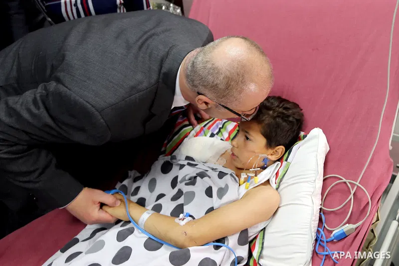 Palestinian Prime Minister Rami Hamdallah visits a nine-year-old Palestinian boy Waqas al-Saifi who lost his arm on Tuesday after being attacked by a bear in the Qalqiliya Zoo, at Najah hospital in the West Bank city of...