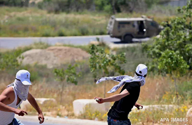 Palestinian protesters hurl stones towards Israeli security forces during clashes at a protest in support of Palestinian prisoners on hunger strike in Israeli jails, in the West Bank village of al-Naqoura, near Nablus on...