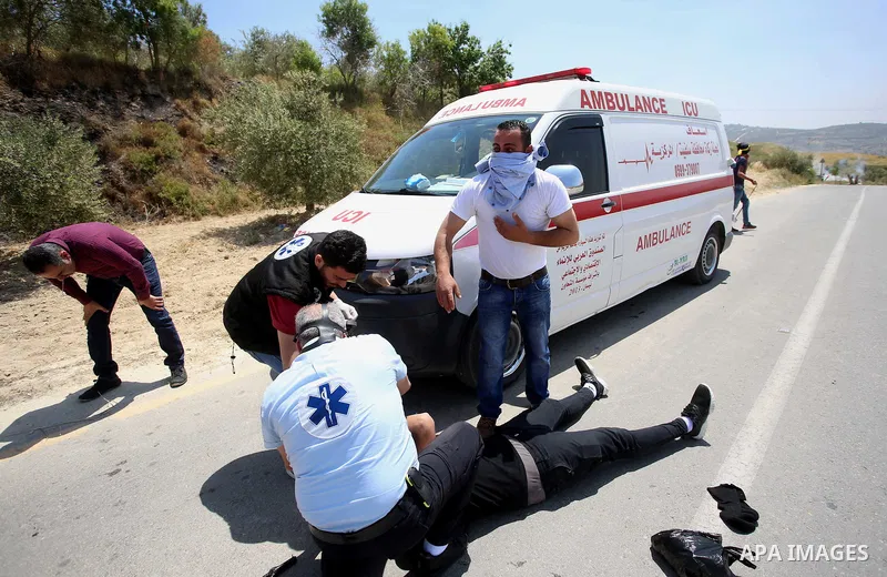 A Palestinian protester is evacuated after he was wounded during clashes with Israeli security forces at a protest in support of Palestinian prisoners on hunger strike in Israeli jails, in the West Bank village of al-Naq...