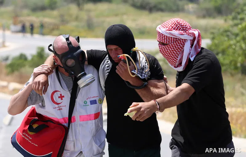 A Palestinian protester is evacuated after he was wounded during clashes with Israeli security forces at a protest in support of Palestinian prisoners on hunger strike in Israeli jails, in the West Bank village of al-Naq...