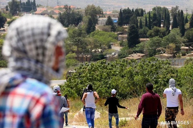 Palestinian protesters hurl stones towards Israeli security forces during clashes at a protest in support of Palestinian prisoners on hunger strike in Israeli jails, in the West Bank village of al-Naqoura, near Nablus on...