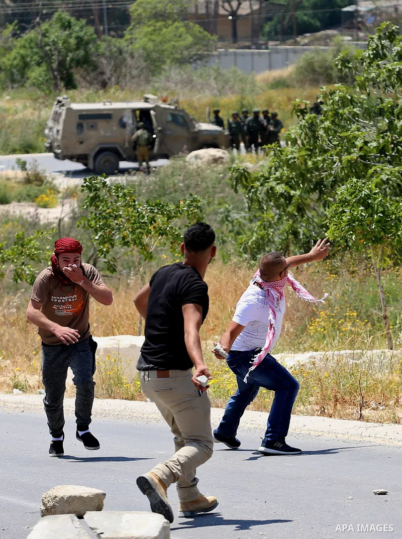 Palestinian protesters hurl stones towards Israeli security forces during clashes at a protest in support of Palestinian prisoners on hunger strike in Israeli jails, in the West Bank village of al-Naqoura, near Nablus on...