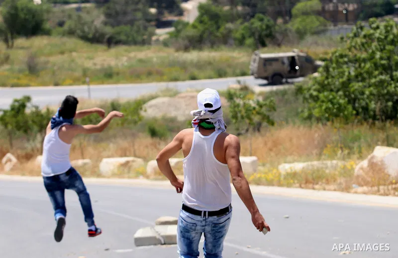 Palestinian protesters hurl stones towards Israeli security forces during clashes at a protest in support of Palestinian prisoners on hunger strike in Israeli jails, in the West Bank village of al-Naqoura, near Nablus on...
