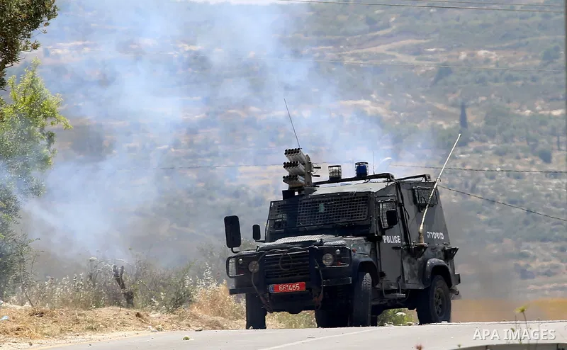 An Israeli security forces jeep is seen during clashes with Palestinian protesters at a protest in support of Palestinian prisoners on hunger strike in Israeli jails, in the West Bank village of al-Naqoura, near Nablus o...